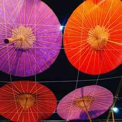 Low angle view of illuminated lanterns hanging at night