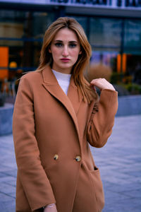 Portrait of young woman standing outdoors