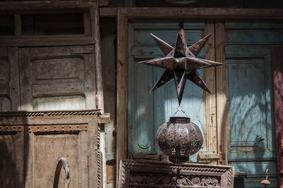 Low angle view of lanterns hanging on old building