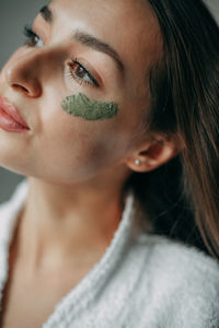 Brunette woman 30 years old with cream on her face