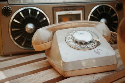 Close-up of old telephone booth on table