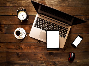 High angle view of coffee and laptop on table