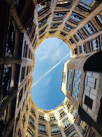 Low angle view. courtyard of a building against sky