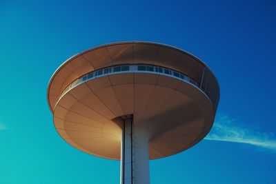 Low angle view of security tower against clear blue sky