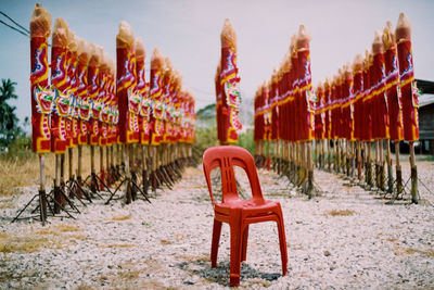 Chairs in row against sky