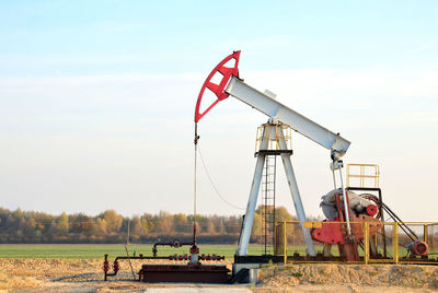 Traditional windmill on field against sky