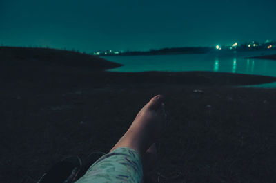 Low section of person relaxing on beach