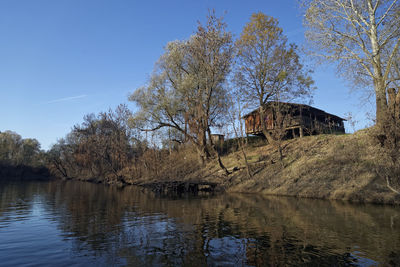 The odra river in autumn with the wooden cottage on the river bank, croatia