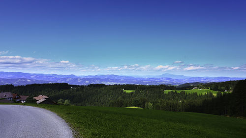 Scenic view of landscape against blue sky