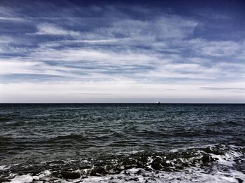 Scenic view of sea against cloudy sky