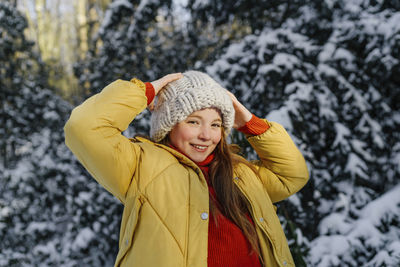 Young woman smiling in snow