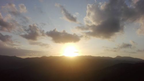 Scenic view of silhouette mountains against sky during sunset