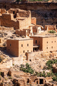 Scenic view of old stone houses, palm trees ghoufi canyon in the aures region, algeria