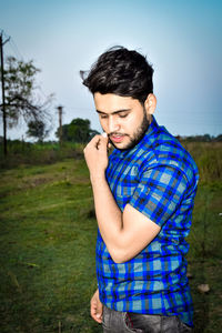 Young man standing on field