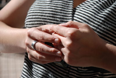 Midsection of woman wearing ring