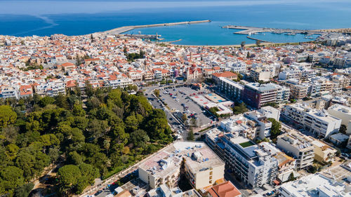 High angle view of townscape by sea against sky