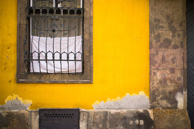 Close-up of yellow wall with window