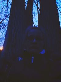 Close-up portrait of man in tree trunk