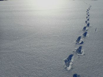 Footprints on snow covered field