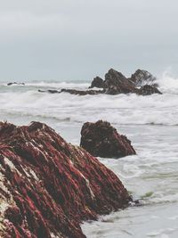 Scenic view of rocks and sea against sky