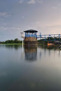 Built structure by lake against sky