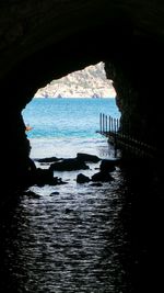 Scenic view of sea seen through arch
