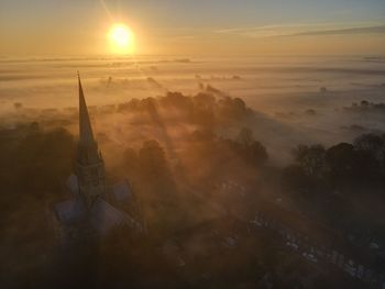 Aerial view of building against sky during sunset