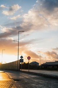 Street lights against sky during sunset