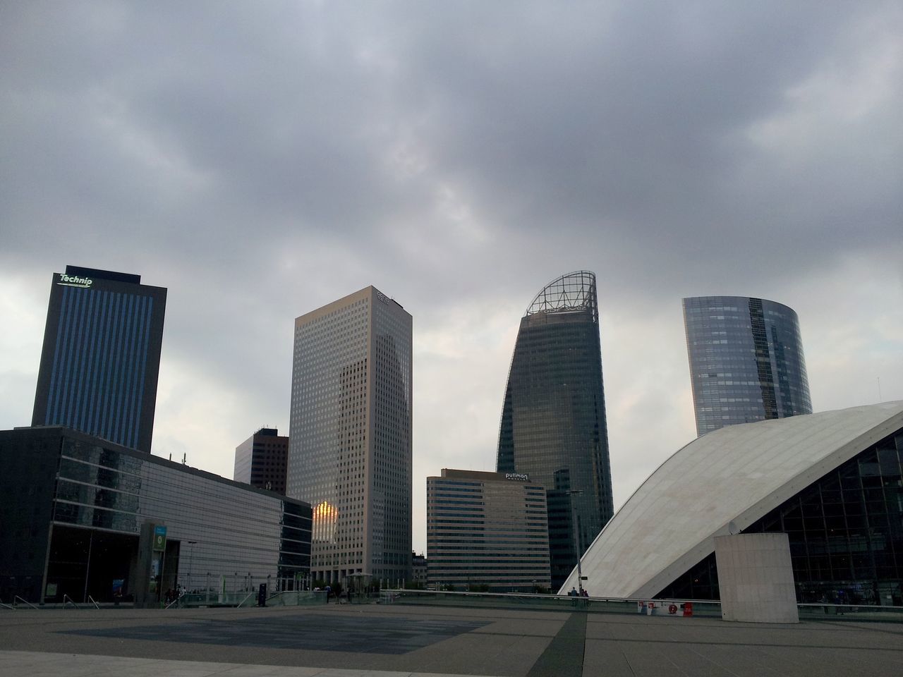 building exterior, architecture, skyscraper, built structure, city, modern, office building, sky, tall - high, cloud - sky, tower, cloudy, urban skyline, low angle view, financial district, cloud, cityscape, building, tall, city life