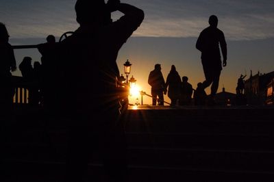 Silhouette of people at sunset