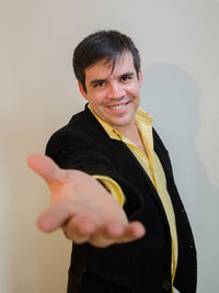 Portrait of businessman gesturing against white background