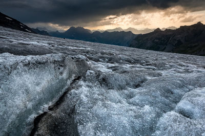 Scenic view of snowcapped mountains against sky during sunset