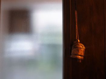 Close-up of window hanging on door at home