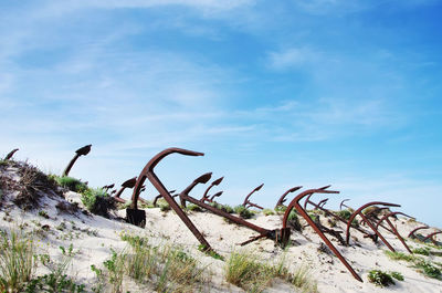 Rusty anchors against sky