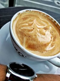 High angle view of cappuccino on table