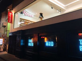 Low angle view of illuminated sign at railroad station at night