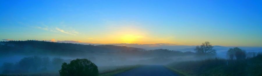Scenic view of landscape against sky at sunset