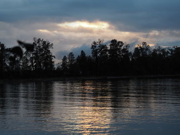 Scenic view of lake against sky during sunset
