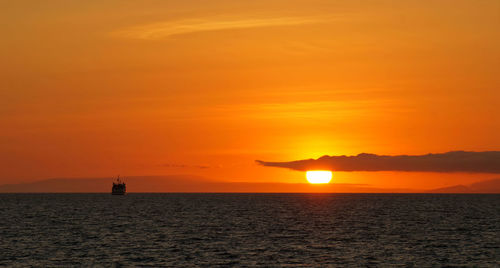 Scenic view of sea against orange sky