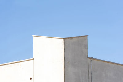 Low angle view of building against clear blue sky