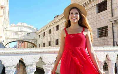 Portrait of smiling young woman in city