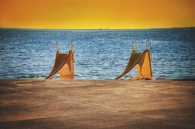 Scenic view of beach against sky during sunset