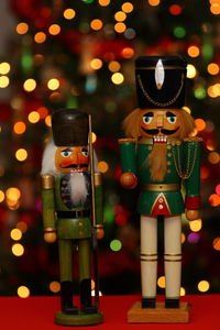 Close-up of figurine with illuminated christmas lights