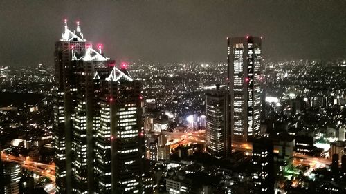 High angle view of city lit up at night