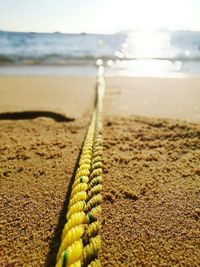 Surface level of sand on beach against sky