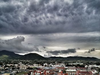 View of cityscape against dramatic sky