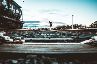 Surface level of railroad tracks against sky