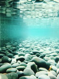 Close-up of pebbles in sea