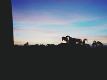 Silhouette landscape against sky during sunset