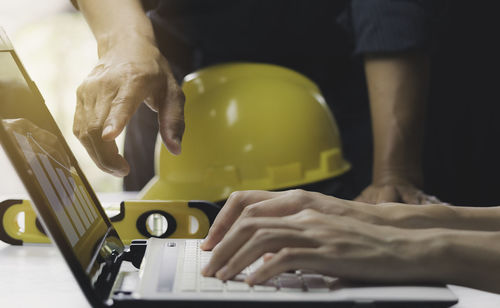 Midsection of man working on table